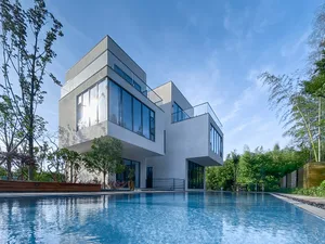 Modern residential home with concrete exterior and large windows.