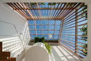Modern minimalist interior with large glass windows and wooden accents.
