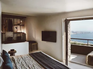 Modern minimalist bedroom featuring concrete, steel, and glass materials.