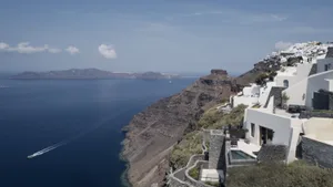 Residential buildings made of stucco and stone, overlooking the ocean.