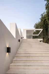 A minimalist staircase constructed with grey stone.