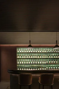 Modern bar counter adorned with green glass tiles