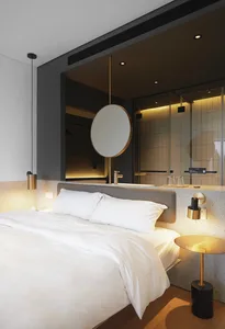 A modern bedroom with a white bed, concrete walls, and a circular mirror.