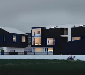 A modern house exterior with concrete walls and a white roof.
