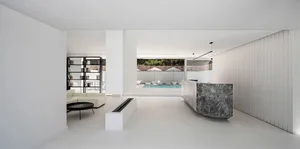 A modern interior space featuring minimalist white marble elements and sleek design.