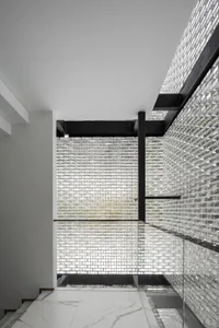 Minimalist interior with white marble floors and glass wall