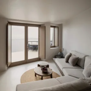 A modern minimalist living room with neutral tones and a view of the sea.
