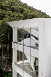 Modern residential building with glass and concrete exterior.