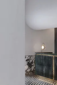 A modern living room featuring a mix of dark and light stone materials.
