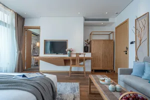A modern bedroom featuring wood furniture and textiles, designed for comfort and style.