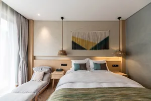 Modern minimalist bedroom featuring wooden furniture and concrete walls.