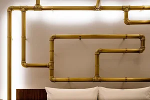 A modern, industrial interior space featuring exposed metal tubing as a decorative element.