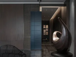 Contemporary lobby interior featuring a metallic abstract sculpture on a black pedestal.
