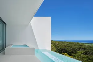 Modern residential patio featuring glass and concrete materials.