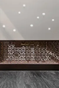 A modern commercial lobby featuring metallic geometric screens