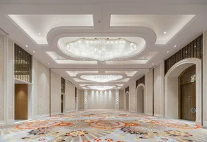 Spacious, modern banquet hall with marble accents and wooden paneling.