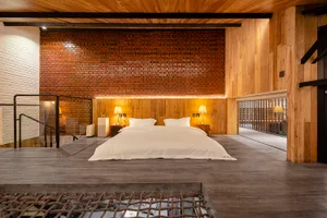 A minimalist bedroom with a bed, nightstands, and lights.