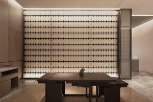Modern hotel lobby featuring glass wall panels and minimalist furniture.