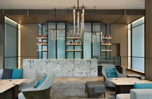 A modern hotel lobby featuring marble and glass elements
