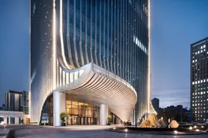 A sleek modern office building entrance with glass and metal elements.