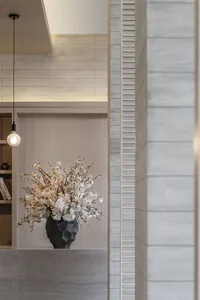 A ceramic vase with white and pink flowers in a modern interior space