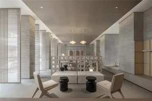 A minimalist interior space featuring concrete materials and modern furniture.