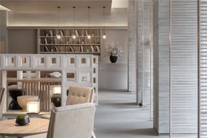 Modern minimalist restaurant interior featuring concrete flooring, wooden furniture, and glass accents.