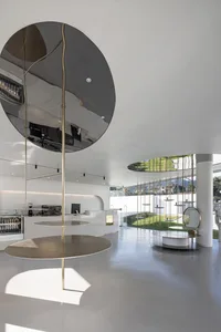 Modern coffee shop interior featuring minimalist design with metal and glass materials.