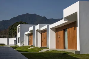 Modern residential buildings with concrete walls and wooden doors and windows.
