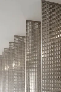 Modern interior design featuring a metal grid wall panel.