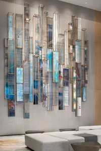 Decorative glass panels arranged vertically on a lobby wall