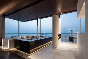 Modern living space with glass walls overlooking the sea