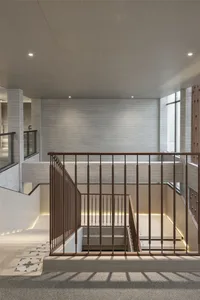 Modern staircase with concrete treads and wooden railings.
