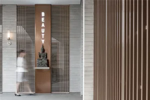 Spa interior with wooden walls, metal accents, and a sign reading 'Beauty'.