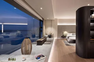 A minimalist residential interior featuring wood flooring and glass windows, with a modern design aesthetic.