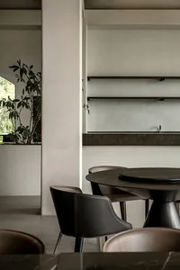 Modern dining room featuring black metal tables and chairs.
