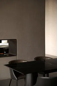 A modern interior featuring a sleek black dining table with contemporary chairs.