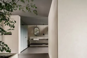 Modern minimalist bathroom featuring concrete flooring and glass walls.
