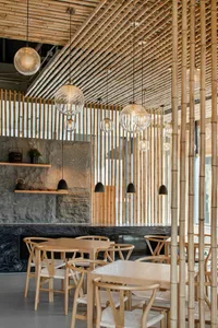 Modern restaurant interior with bamboo ceiling and lighting fixtures