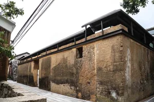 Modern building exterior with stucco facade and black roof structure
