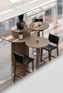 Modern cafe with round wooden tables and black woven leather chairs.
