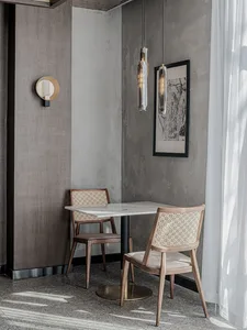 Modern commercial design featuring a restaurant table setting with a contemporary table and chairs, designed with minimalist