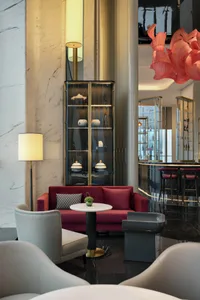 Modern hotel lounge with marble furniture and contemporary design elements.