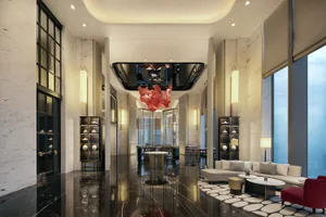 A modern lobby featuring marble materials and contemporary design elements.