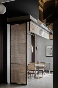 Modern restaurant interior featuring brass accents and wooden furniture.