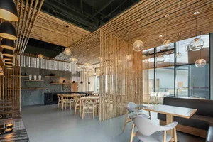 A modern restaurant interior featuring wood elements and hanging lights.