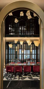 A modern restaurant interior featuring mixed materials, with a focus on the dining area and unique lighting fixtures.