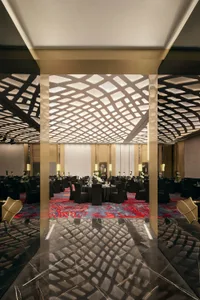 A grand ballroom featuring modern design with marble, metal, and glass elements.