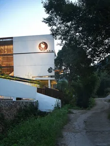 A modern building with concrete and steel exterior materials.
