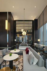 A modern hotel lobby with marble flooring and contemporary seating arrangements.